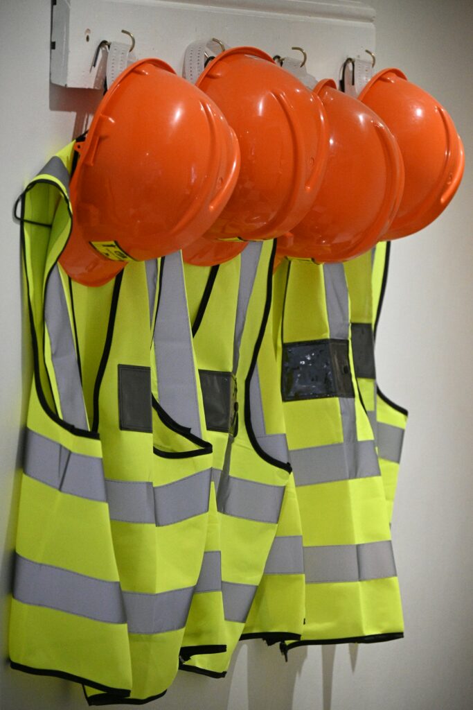 Hi-vis vests and hard hats hanging ready for the next swing
