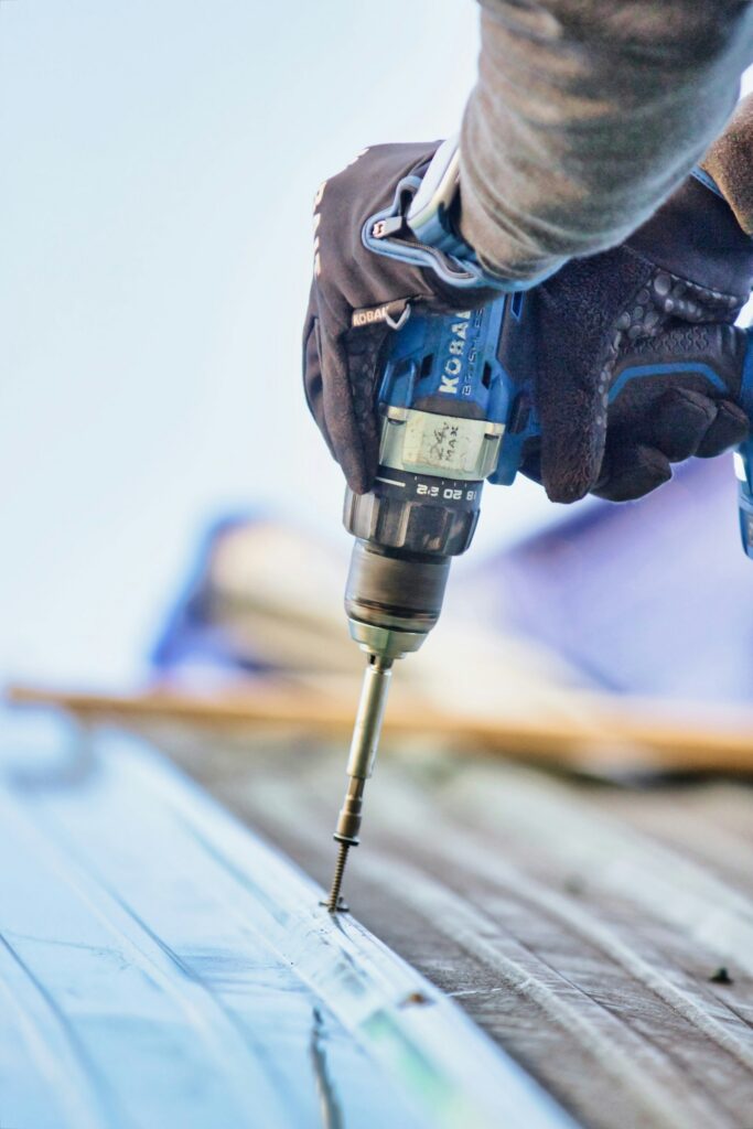 Tradesperson using a cordless drill on timber